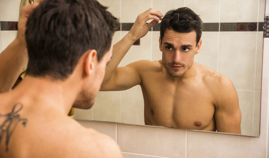 checking hair in mirror