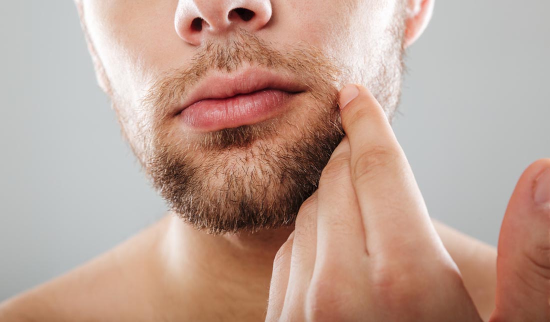 closeup hand touching beard