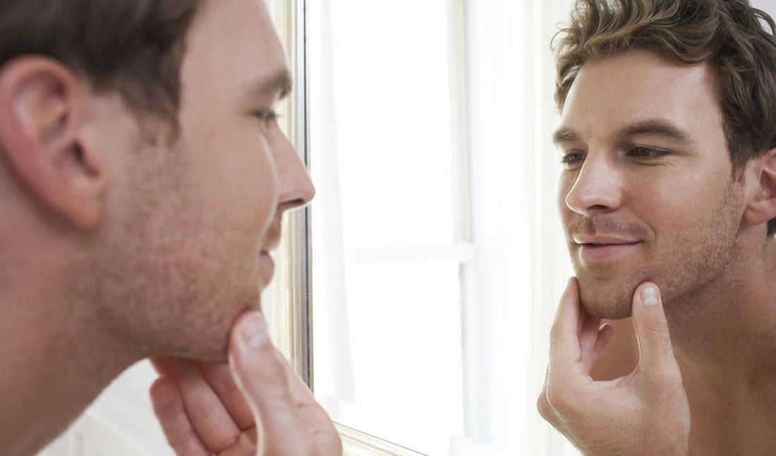 closeup of man examining stubble