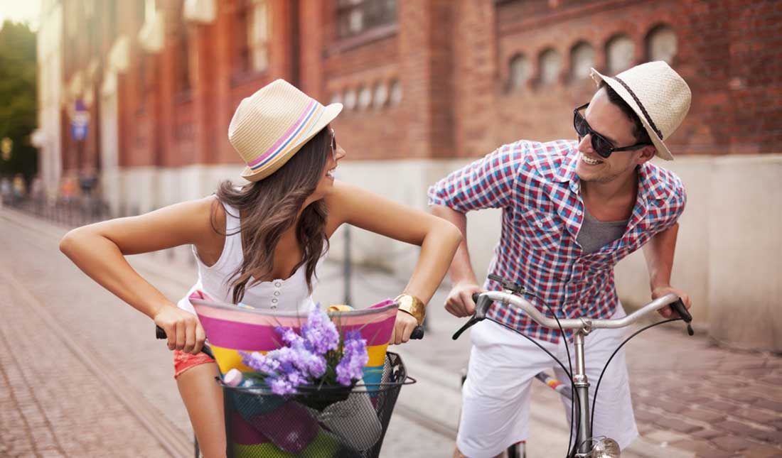 couple riding bikes in street