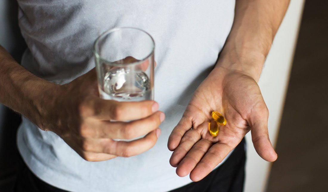 fish oil capsules in hand