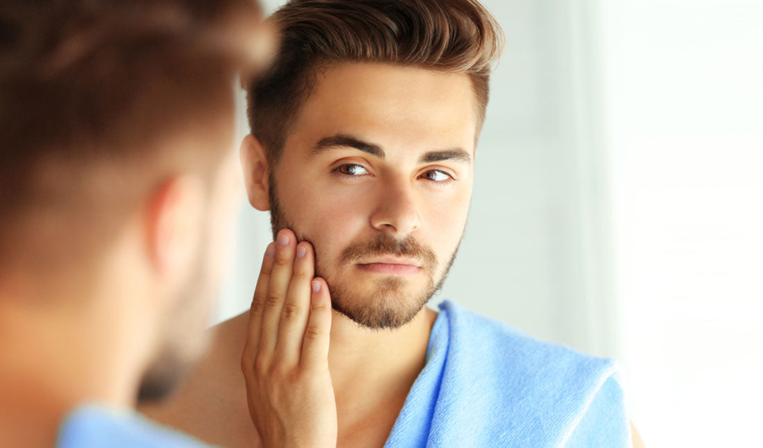 guy with beard looking in mirror