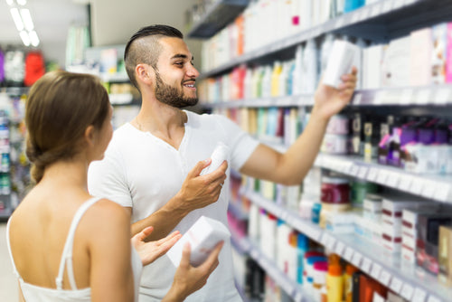 man buying cosmetic cream in store