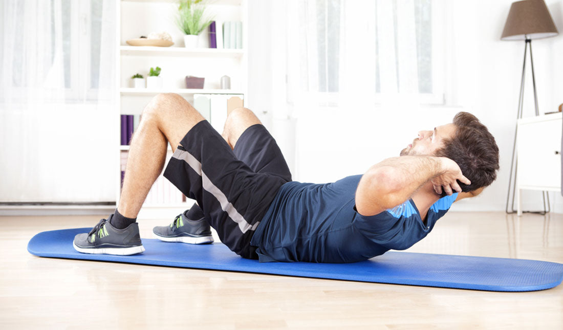 man doing crunches on mat