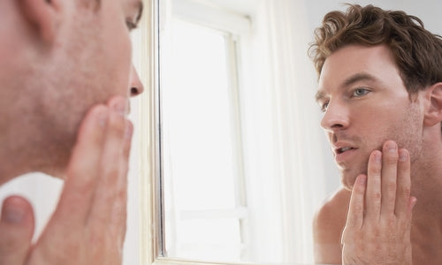 man examining his stubble