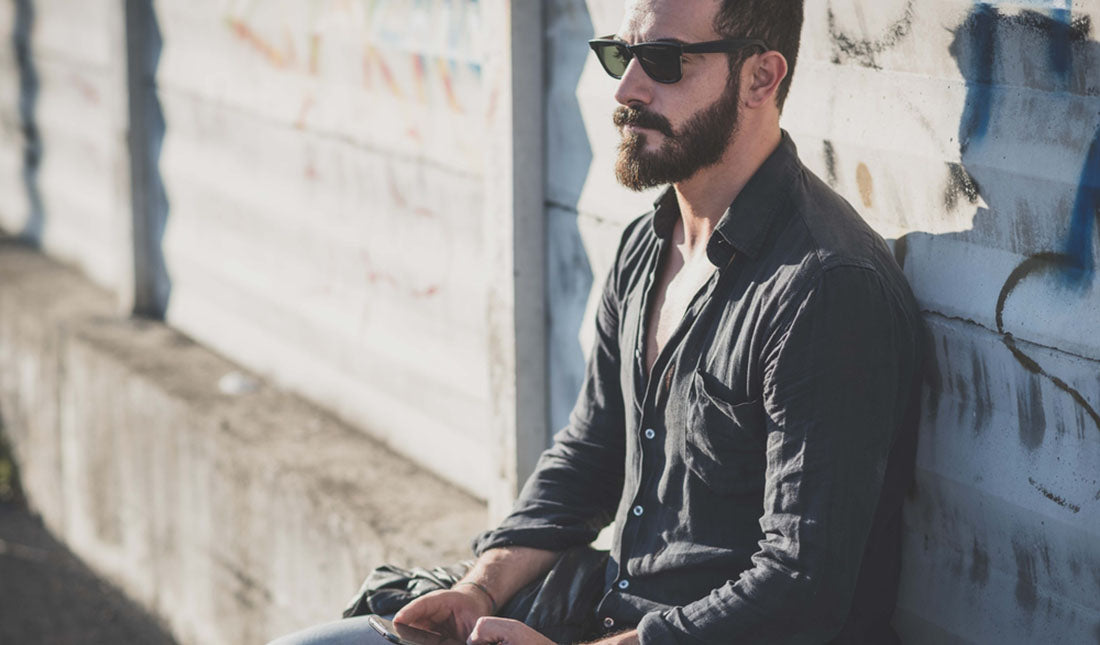 man sitting outside using phone