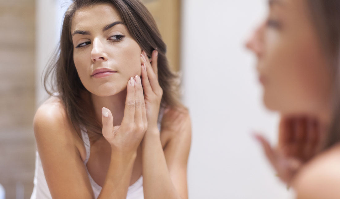 woman checking face reflection