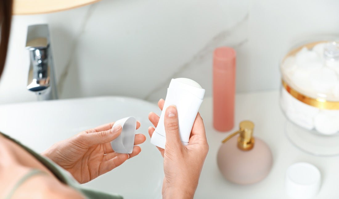 woman holding stick deodorant