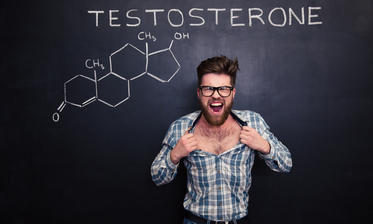 Young man tearing his shirt against blackboard with testosterone formula