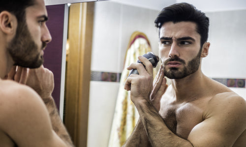 young man using shaving machine